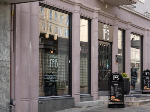 a store front with glass windows on a street at Hotel No13 in Bergen