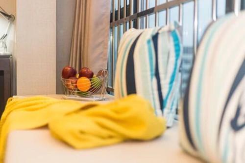 a table with a bowl of fruit in a crib at Livetour Hotel Kehui Golden Valley Guanzhou in Guangzhou