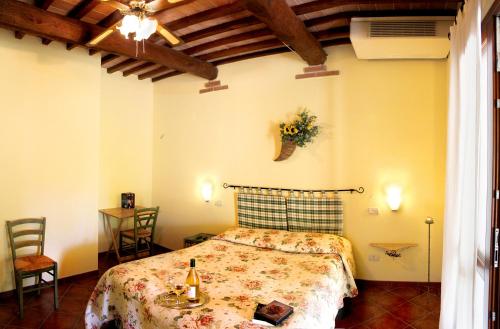 a bedroom with a bed and a table and chairs at Il Gaggiolo in Rispescia