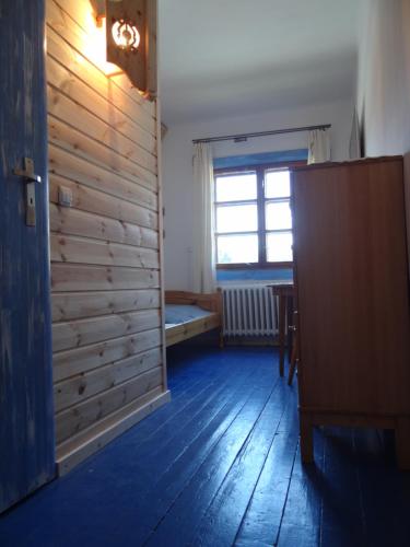 an empty room with a wooden wall and a door at Schody Do Nieba in Zakopane