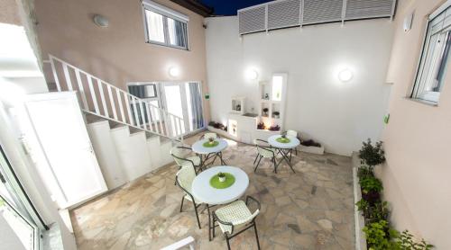 a room with tables and chairs and a staircase at Five Rivers Rooms in Mostar