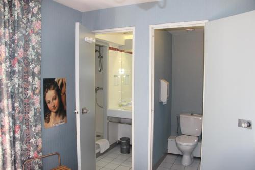 uma casa de banho com um WC e um lavatório em Hôtel Le Catala em Beaudéan
