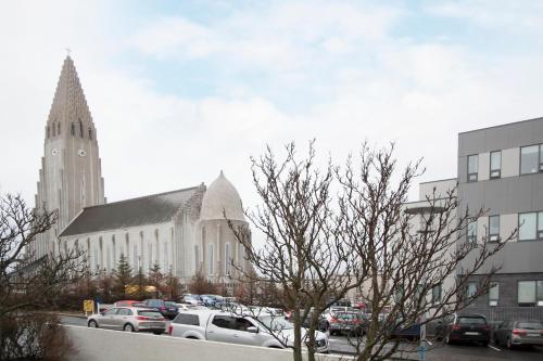 a church with cars parked in a parking lot at Eric the Red Guesthouse in Reykjavík