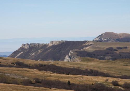 a view of a field with mountains in the background at Touroulet in Suze