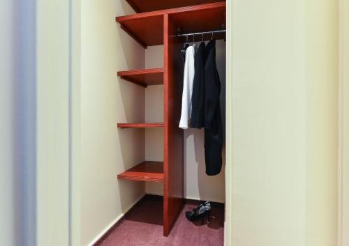 a walk in closet with red wood shelves at Maison Du Pré in Paris