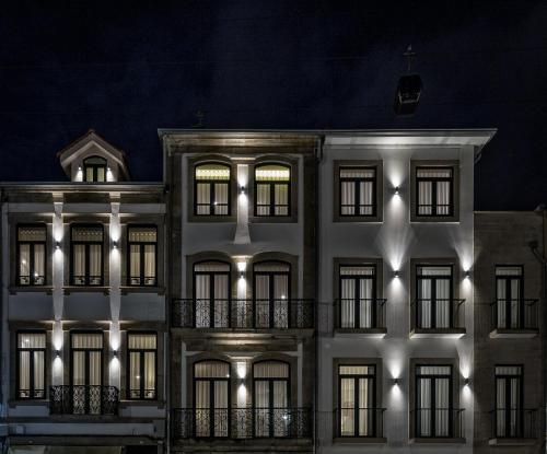 a white building with lights on it at night at 296 Heritage Apartments in Vila Nova de Gaia