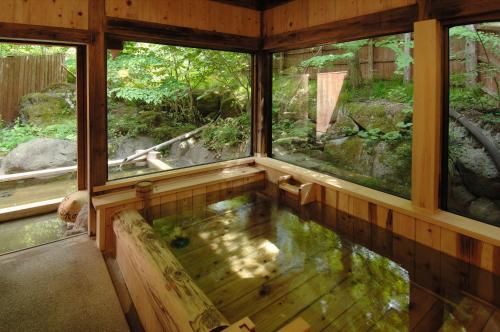 an inside view of a house with a pool of water at Katsuragi no Sato in Takayama
