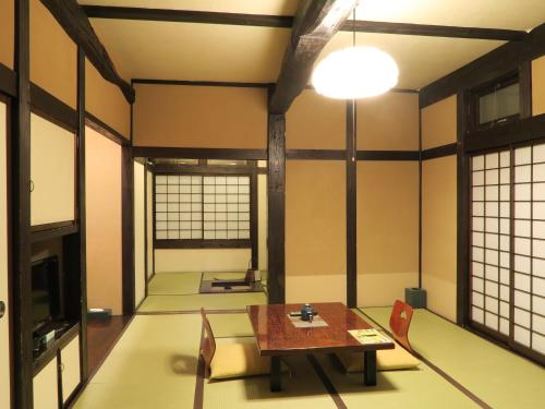 an empty room with a table and chairs at Katsuragi no Sato in Takayama