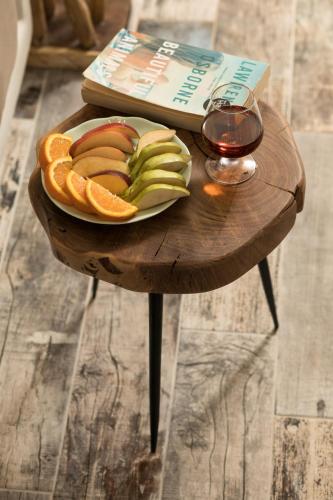 a plate of fruit and a glass of wine on a table at Naxos Petite Studios in Agios Prokopios