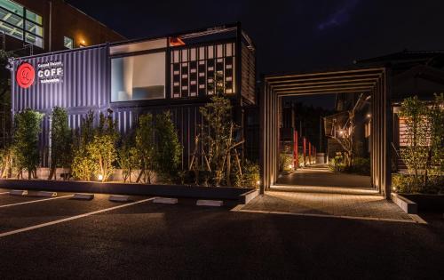 an external view of a building at night at HOTEL R9 Kujukuri "ex Casual Resort COFF Ichinomiya" in Ichinomiya