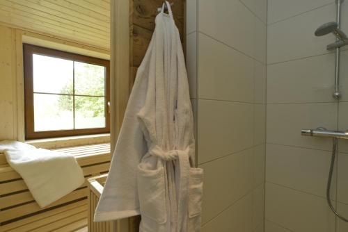 a bathroom with a white towel hanging on a wall at Feriendorf Berghof in Heiligen Gestade