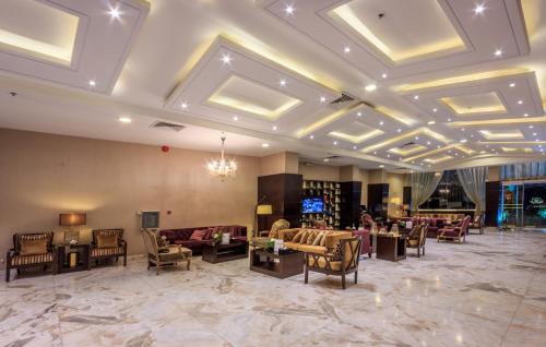 a lobby with couches and chairs and a chandelier at Al Muhaidb Down Town - King Fahd Road in Riyadh