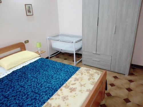 a bedroom with a bed and a dresser at Da Elisa in Riomaggiore