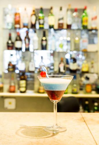 a martini glass with a cherry on a counter at Costarenas Hotel & Spa in Colón