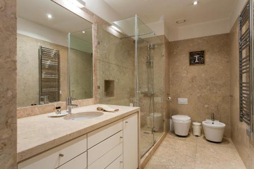 a bathroom with a sink and a shower and a toilet at Apartment Carmo in Lisbon