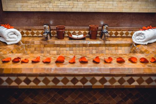 a bunch of orange food sitting on top of a counter at Ambre Epices Medina Riad in Marrakech