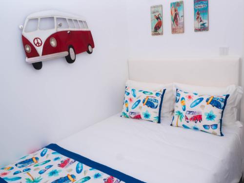a bedroom with a bed with a toy van on it at Cantinho das Flores I in Nazaré