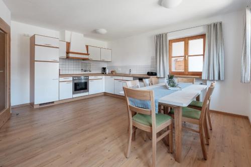 a kitchen with a table and chairs in a room at Haflingerhof - Oberjoch in Bad Hindelang