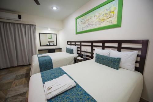 Postel nebo postele na pokoji v ubytování Hotel Andiroba Palace