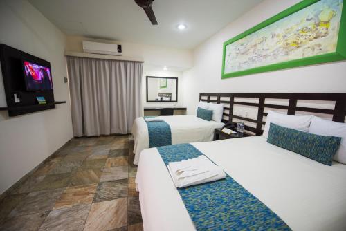 En eller flere senger på et rom på Hotel Andiroba Palace