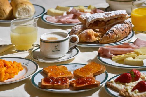 a table with plates of breakfast foods and a cup of coffee at Ponty Orsó Vendégház in Nagybaracska