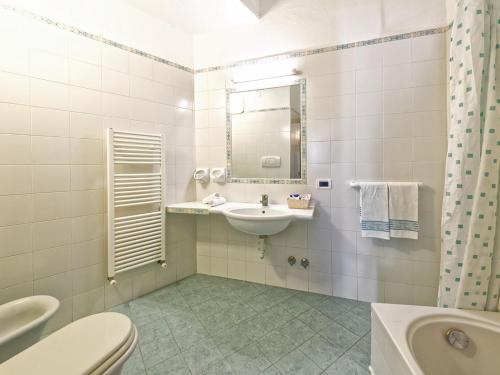 a bathroom with a sink and a toilet and a mirror at Hotel Villa Franz in Ischia