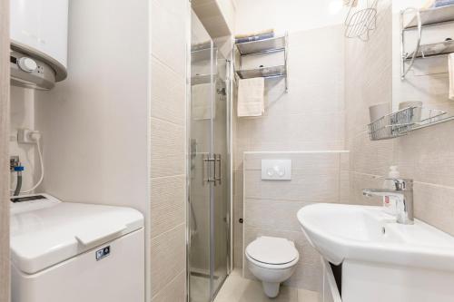 a small bathroom with a toilet and a sink at Apartment DeLux in Split
