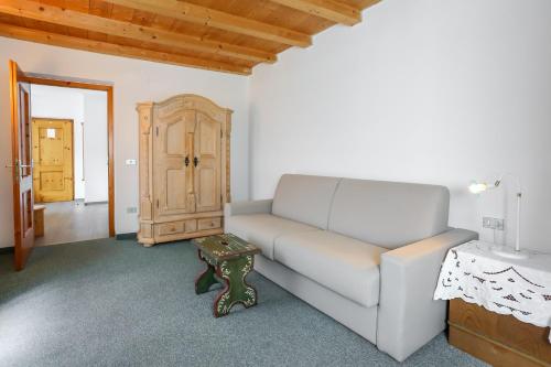 a living room with a couch and a table at Garni Meinrad in Ora/Auer