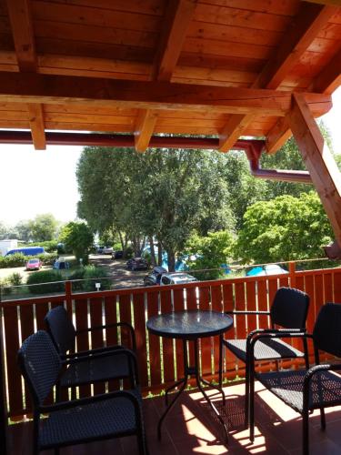 a patio with chairs and a table on a deck at Penzion U Raka in Pasohlávky