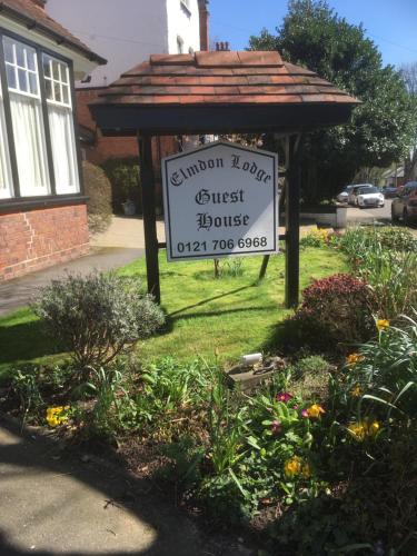 a sign for a guest house in a garden at Elmdon Lodge in Birmingham