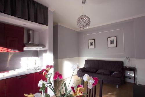 a living room with a couch and a kitchen at Hotel Residence Magnolia in Rome
