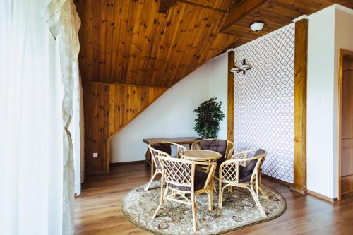 a dining room with a table and chairs at Apartamenty U BARBARY in Ełk