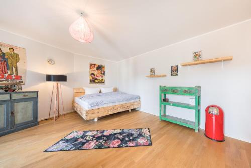 a bedroom with a bed and a rug on the floor at Design Apartments - "Potsdam West", 80 in Potsdam