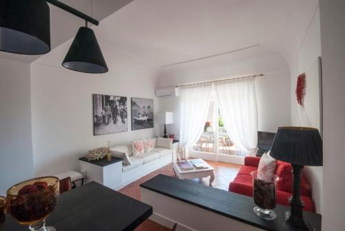a living room with a couch and a table at Carthusia Suites in Capri