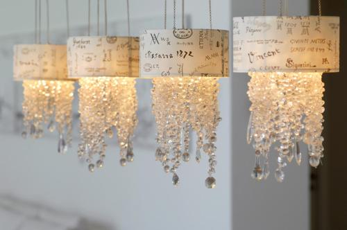 a bunch of lights hanging in a room with signs at Villa Alice Caesarea in Caesarea