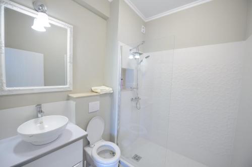 a bathroom with a shower and a toilet and a sink at Complex Bavaro in Mamaia Sat/Năvodari