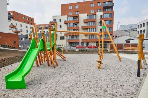 a playground with green and yellow swings at Residence Nad Vltavou in Prague