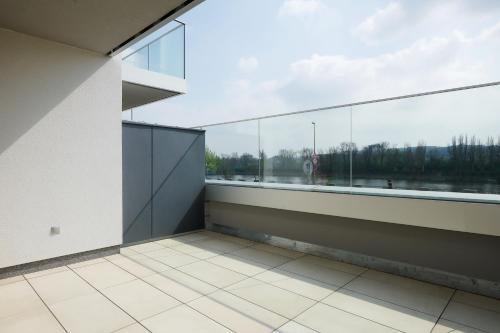 an empty room with a large window in a building at Residence Nad Vltavou in Prague