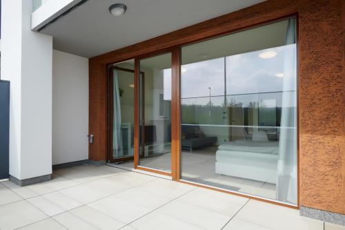 an open glass door of a house with a patio at Residence Nad Vltavou in Prague