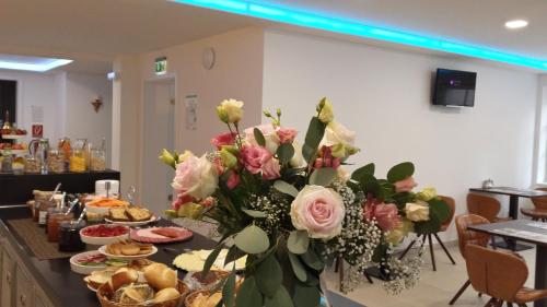 a table with a bunch of flowers on it at Boutique-Hotel Kronenstuben in Ludwigsburg