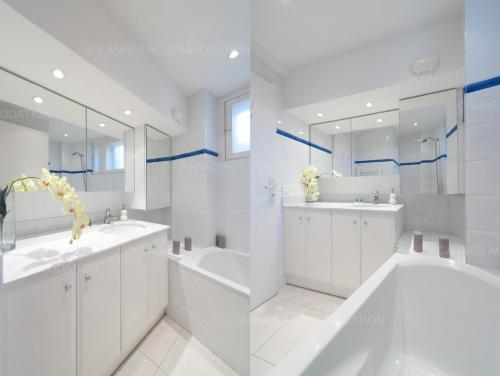 La salle de bains blanche est pourvue de 2 lavabos et d'une baignoire. dans l'établissement Blanc cel, à Cannes