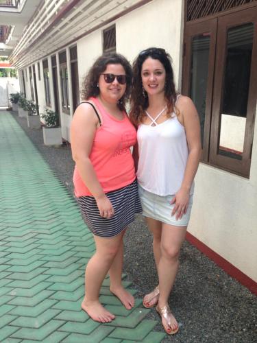 two women standing next to each other in front of a building at Cinnamon Airport Residencies in Katunayaka