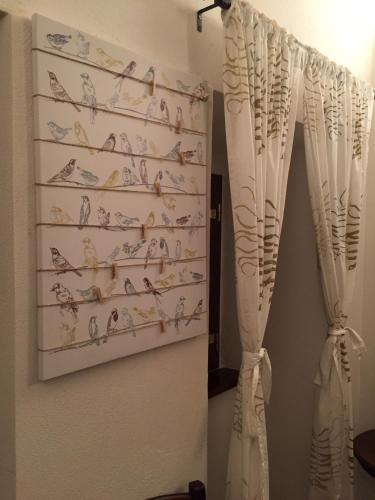 a curtain with birds on it hanging on a wall at Montagna & Relax in Castel di Sangro