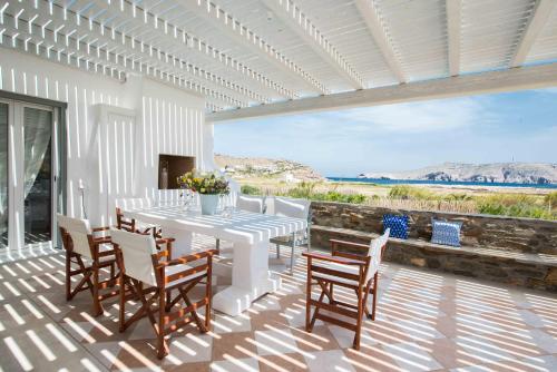 a dining room with a table and chairs on a patio at Mykonos Cocooning in Mykonos