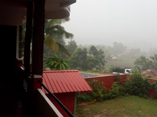 a view from a house with a red roof at Green Villa in Virajpet