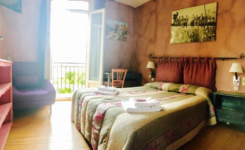 een slaapkamer met een bed en een groot raam bij Boutique Hotel Couleurs Suds in Cannes