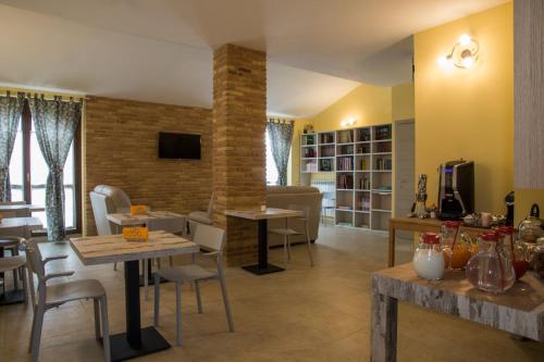 a living room with tables and chairs and a couch at BorgoPratole CountryHouse in Cingoli
