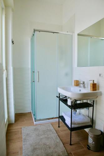 a bathroom with a glass shower and a sink at Andolfi 24 Rooms in Pompei