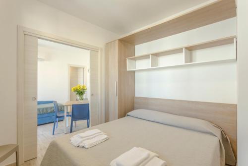 a bedroom with a bed with two towels on it at Case Vacanza appartamenti Trinacria in San Vito lo Capo