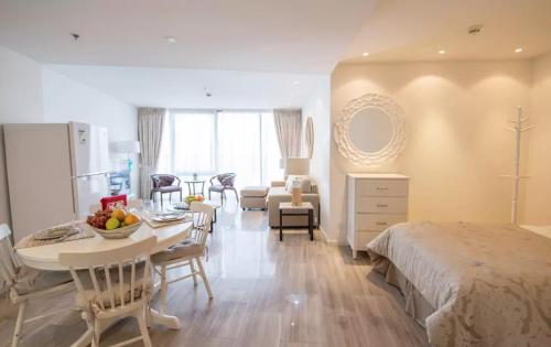 a bedroom with a bed and a table with fruit on it at Mayfair Serviced Apartment - D1 Tower in Dubai